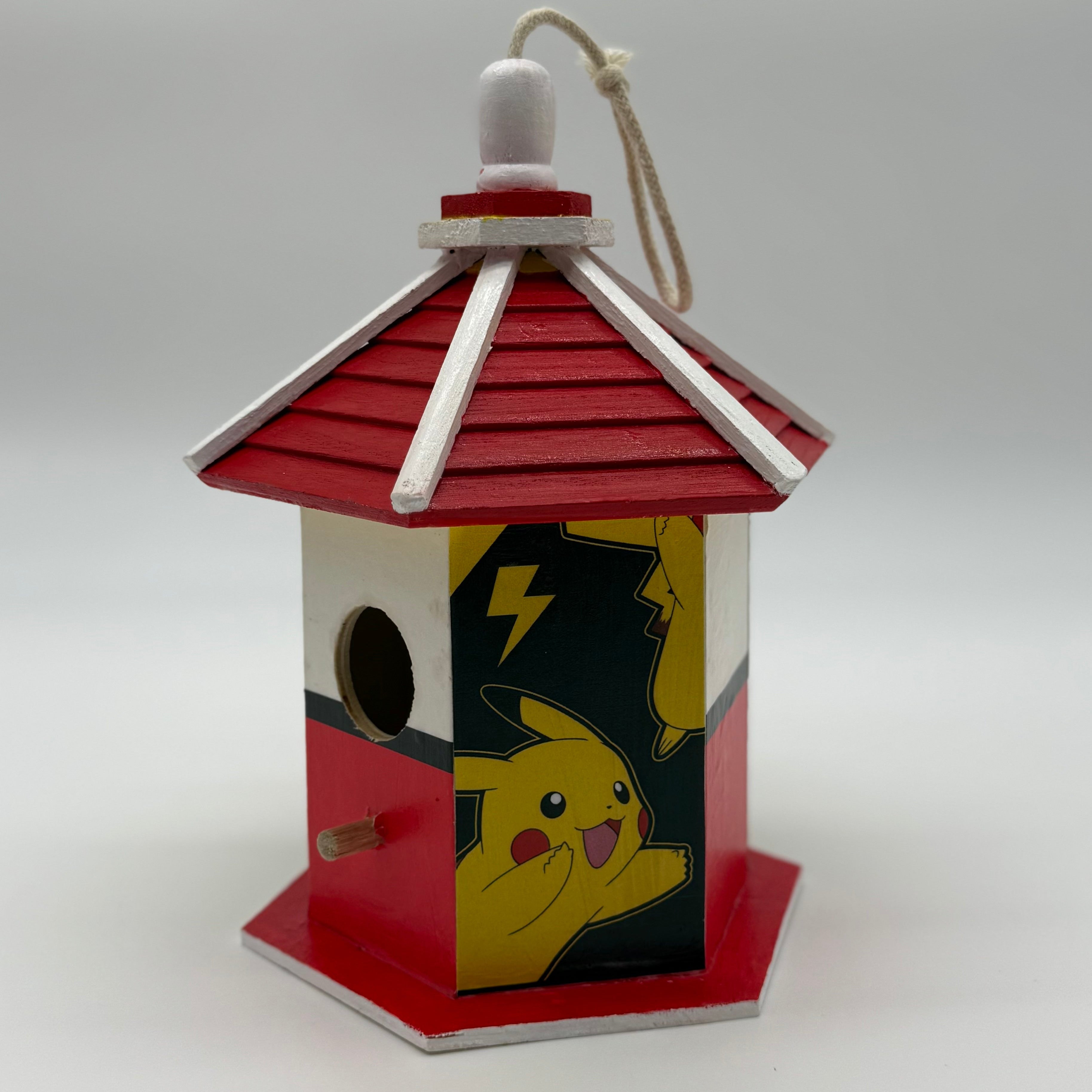Birdhouse with Pikachu design on a white background
